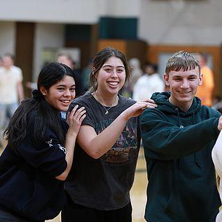 学生 participate in an activity in the university gymnasium.